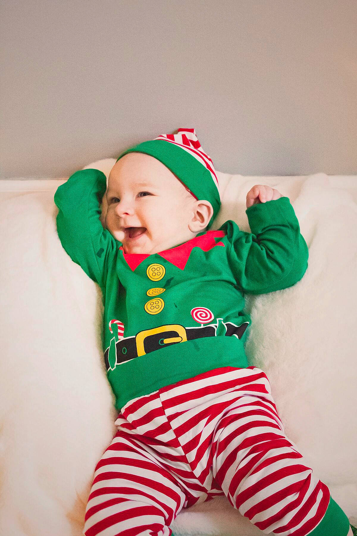 Kylo is registered to the contest to win money with this photo: baby, baby_products, baby_toddler_clothing, child, christmas, fictional_character, green, headwear, holiday, pajamas, person, sleeve, toddler