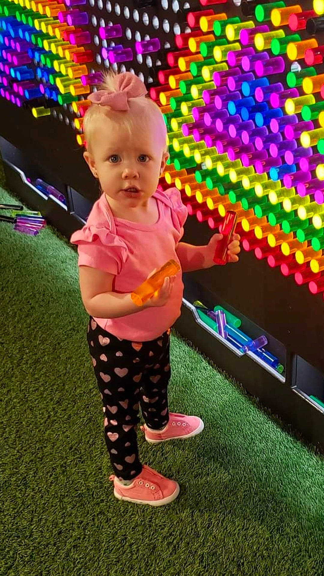 Brynna joined the competition — help win amazing prizes! baby, baby_toddler_clothing, child, design, event, eye, face, foot, fun, grass, happy, human_leg, knee, magenta, pattern, person, pink, play, sandal, sitting