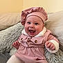 baby, buttoned_jacket, child, cozy, cushion, cute, face, furniture, hands, happy, hat, indoor, infant, pillow, pink_clothing, portrait, sitting, smiling, soft_texture, white_tights