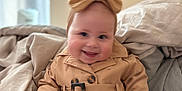 Tahleah joined the competition — help win amazing prizes! baby, bed, blanket, bow, child, clothing, cozy, cute, fashion, happy, headband, indoor, infant, jacket, person, portrait, smile, soft_focus, toddler, warm