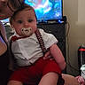 Preston joined the competition — help win amazing prizes! baby, child, infant, portrait, sitting, pacifier, bow_tie, suspenders, white_shirt, red_shorts, formalwear, smiling, indoor, living_room, television, adult, parent, furniture, home, casual_photo