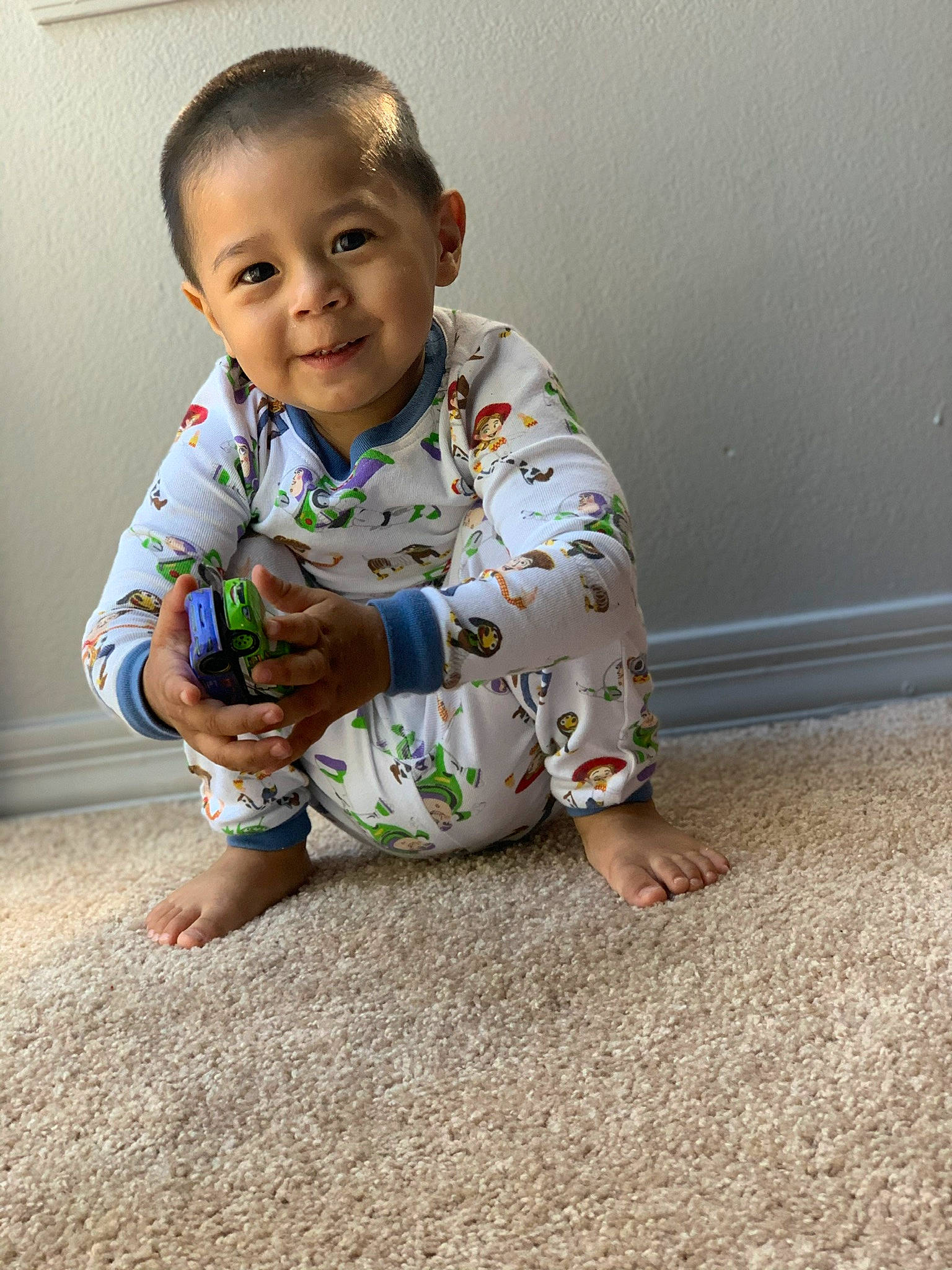 Alonzo is registered to the contest to win money with this photo: ankle, baby, baby_toddler_clothing, barefoot, carpet, child, crawling, curious, ear, finger, floor, flooring, foot, hand, human_body, joy, nail, nightwear, person, play