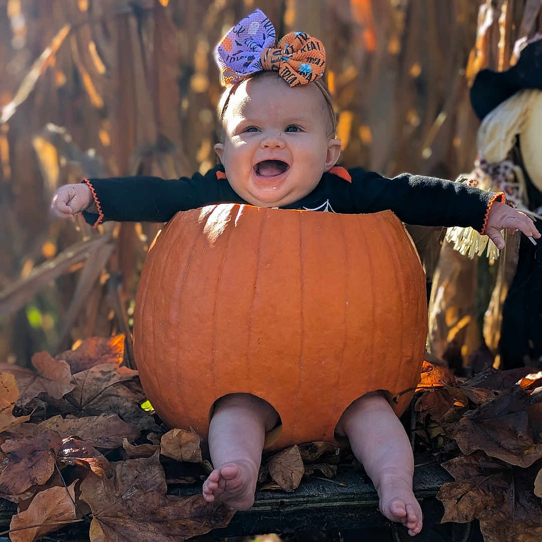 Kalayah is registered to the contest to win money with this photo: baby, bodypart, cap, clothing, face, finger, food, hand, head, leaf, machine, person, photography, plant, portrait, produce, pumpkin, squash, vegetable, wheel