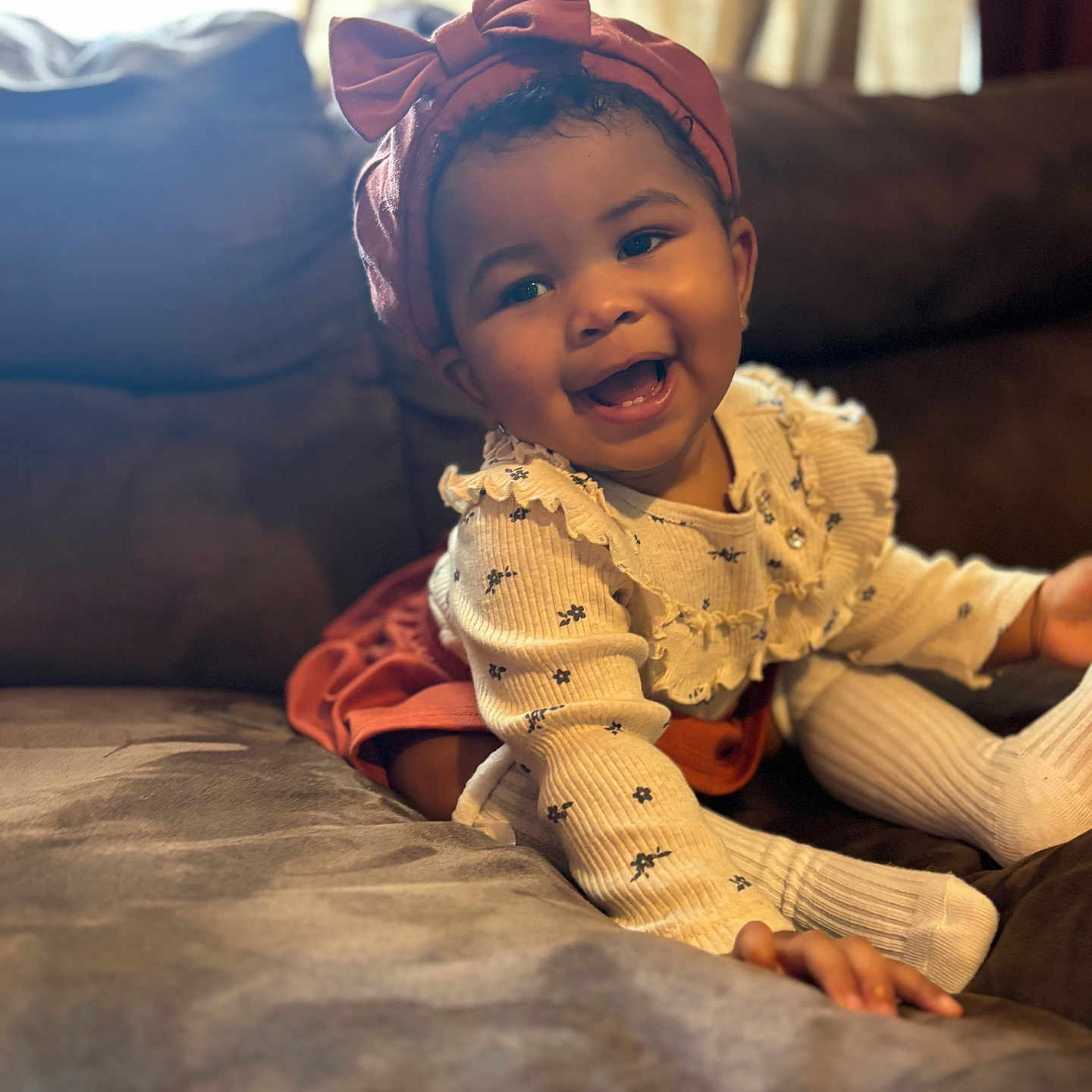 Na'Liyah is registered to the contest to win money with this photo: baby, babylaughing, bodypart, bonnet, cap, clothing, couch, face, finger, furniture, hand, happy, hat, head, knitwear, person, photography, portrait, sitting, smile