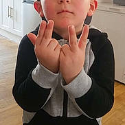 Lymëo a rejoint le concours — aidez-le/la à gagner de superbes lots ! child, boy, cap, baseball_cap, hoodie, sweatpants, hand_gesture, pose, face, ears, kitchen, refrigerator, wooden_floor, indoors, portrait, standing, expressionless, casual_clothing, young_child, home