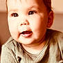 baby, child, infant, face, portrait, smile, cute, hair, eyes, clothing, green, ribbed, close_up, indoors, soft_light, young, skin, expression, person, head