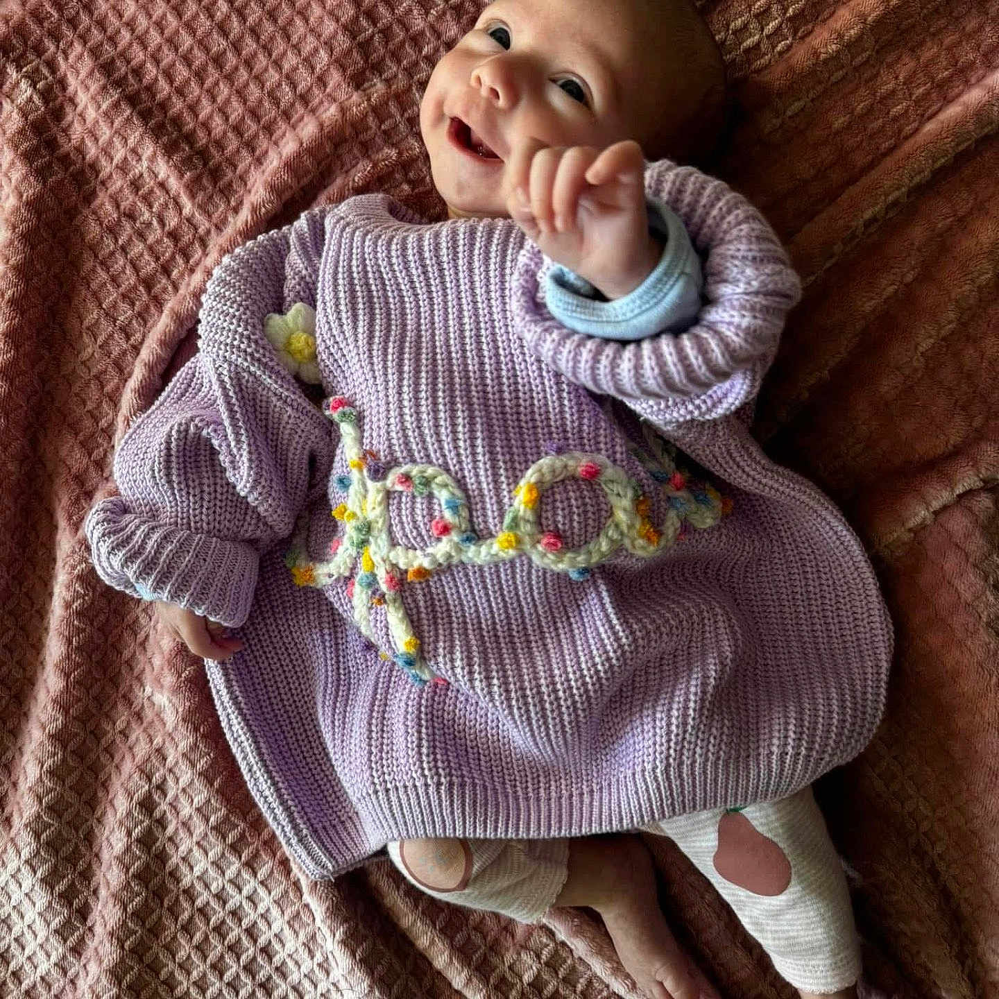 Opal is registered to the contest to win money with this photo: baby, babylaughing, blanket, clothing, face, happy, head, knitwear, newborn, pants, person, photography, portrait, quilt, sitting, sleeve, smile, sweater, yawning