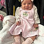 baby, blanket, car_seat, child, clothing, cozy, cute, dress, happy, headband, indoors, infant, person, pink_bow, portrait, seated, smiling, socks, soft, toy