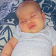 Asma participe au concours pour gagner de l'argent avec cette photo : baby, sleeping, onesie, blanket, indoor, infant, pattern, furniture, television, home, child, person, resting, comfort, soft, cute, peaceful, skin, arm, head