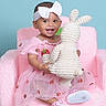 baby, child, pink_dress, headband, white_bow, plush_toy, bunny, chair, smiling, cute, happy, indoor, portrait, footwear, baby_shoes, soft_texture, pastel_colors, toddler, female, studio_photo