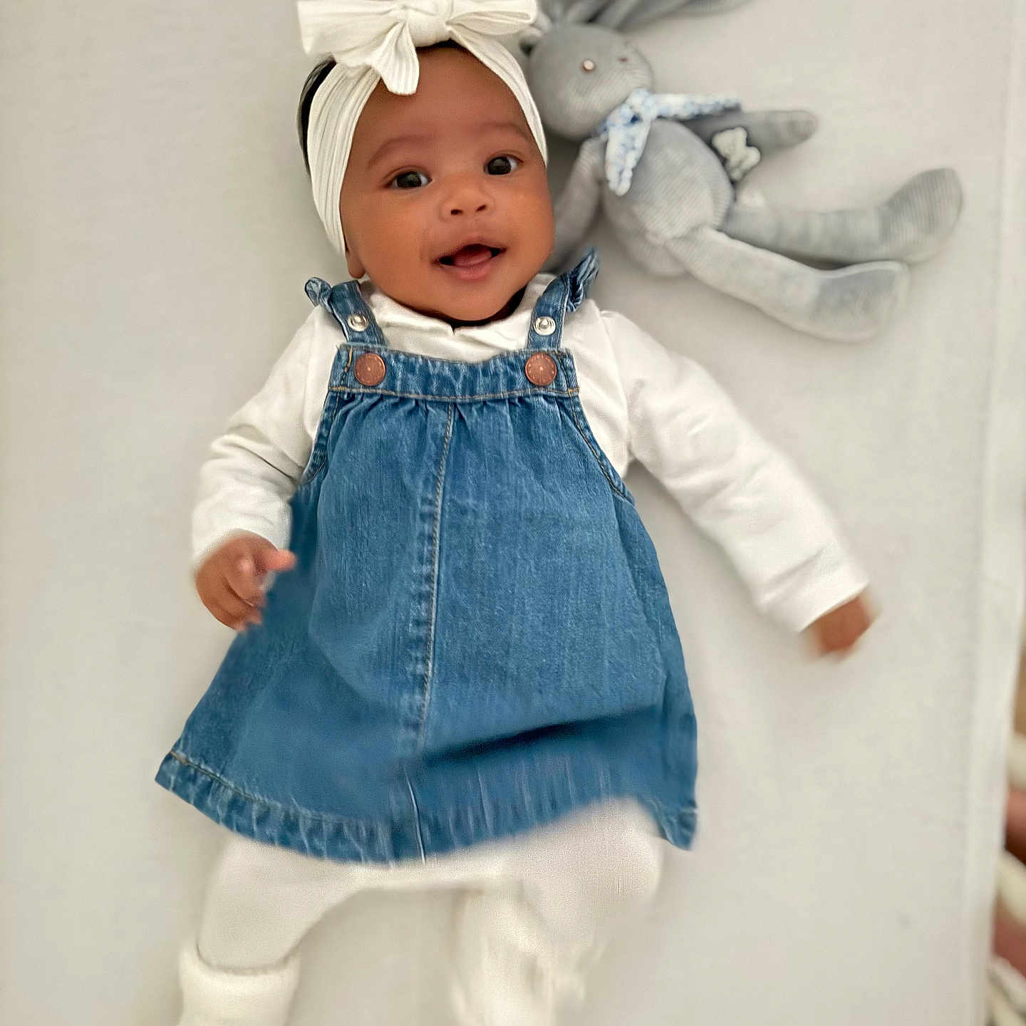 Safia participe au concours pour gagner de l'argent avec cette photo : adorable, baby, bunny, child, cozy, cute, denim_dress, happy, headband, indoors, infant, lying_down, playful, portrait, smiling, soft_blanket, stuffed_toy, toy, white_bow, white_clothing