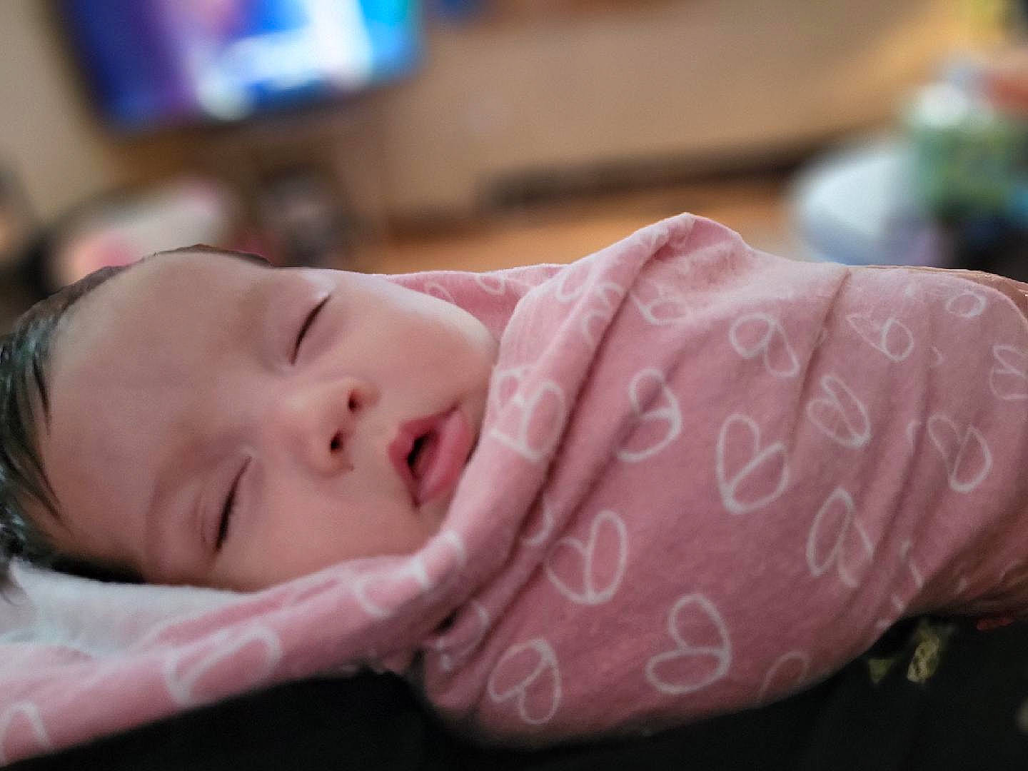 Renesmee is registered to the contest to win money with this photo: baby, baby_toddler_clothing, bedtime, cheek, child, comfort, ear, eyelash, fun, happy, headgear, linens, lip, magenta, nose, person, portrait_photography, skin, smile, television