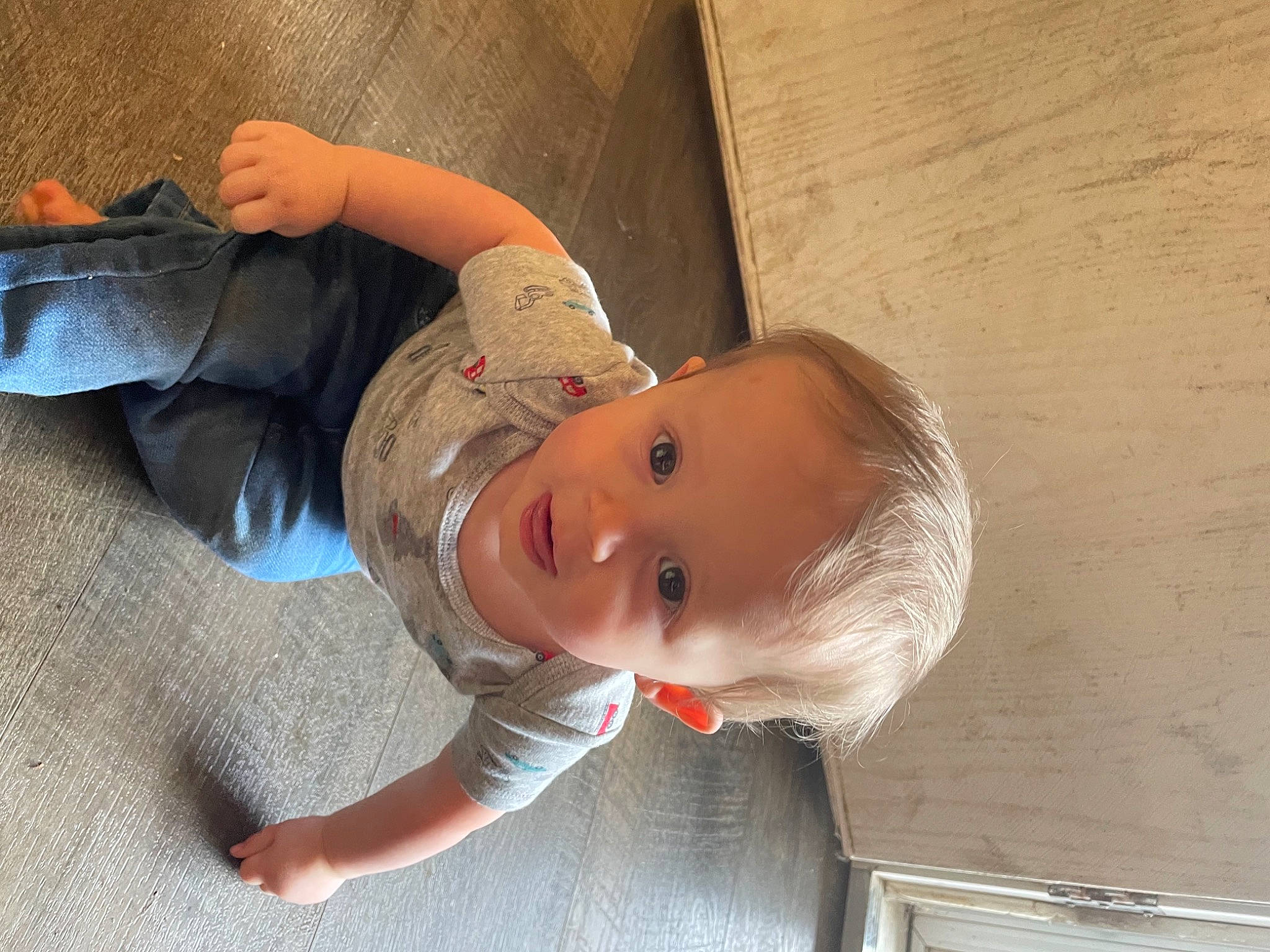 Donald is registered to the contest to win money with this photo: baby, baby_products, baby_toddler_clothing, cheek, chest, child, clothing, comfort, elbow, finger, foot, fun, happy, person, personal_protective_equipment, sitting, smile, thumb, toddler, wood