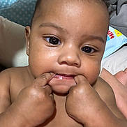 Riyeem joined the competition — help win amazing prizes! baby, blanket, cheeks, child, closeup, curious, cute, expression, eyes, face, fingers, hand, indoors, infant, mouth, person, portrait, skin, soft, young