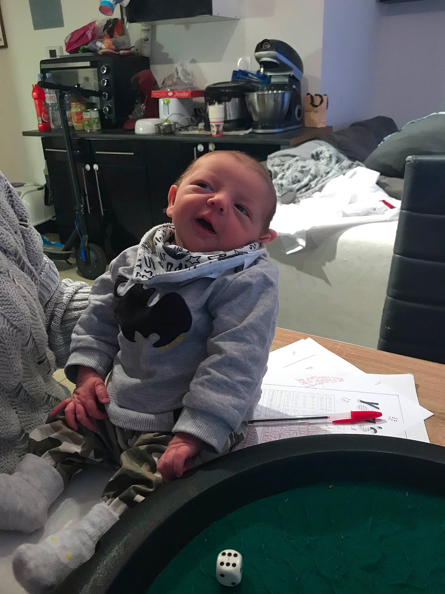 Loukas participe au concours pour gagner de l'argent avec cette photo : baby, baby_products, baby_toddler_clothing, baize, black, child, comfort, event, fun, indoor_games_and_sports, lamp, lap, leisure, person, product, recreation, room, sitting, smile, television