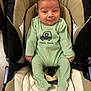 Samy a rejoint le concours — aidez-le/la à gagner de superbes lots ! baby, infant, car_seat, green_onesie, smile, face, child, seatbelt, fabric, clothing, indoor, cute, expression, person, newborn, footed_pajamas, plush, soft, cheeky, young