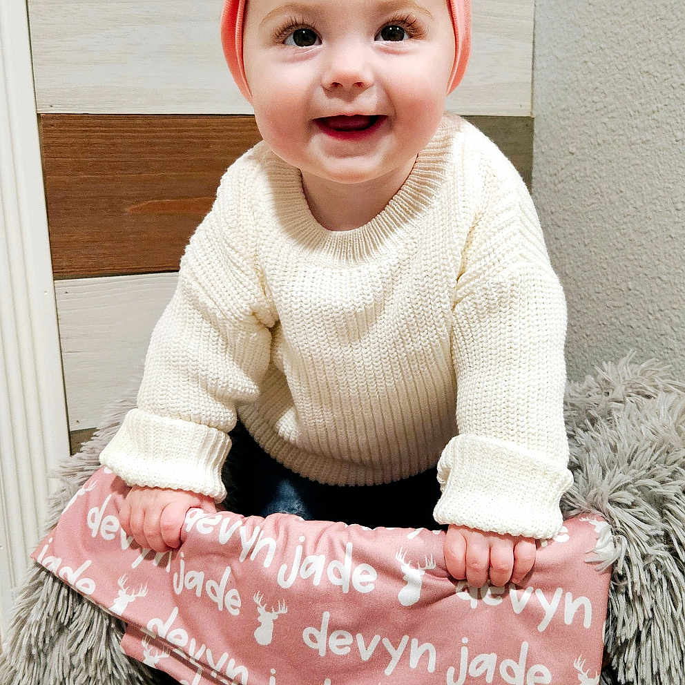 Devyn joined the competition — help win amazing prizes! accessories, baby, bag, basket, clothing, dress, face, handbag, happy, hat, head, knitwear, pants, person, photography, portrait, purse, sitting, smile, sweater