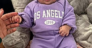 Amana a rejoint le concours — aidez-le/la à gagner de superbes lots ! baby, blanket, casual_wear, child, comfort, cozy, cushion, cute, expression, face, furniture, hand_holding, indoor, infant, person, portrait, purple_clothing, sitting, small_hands, soft_texture