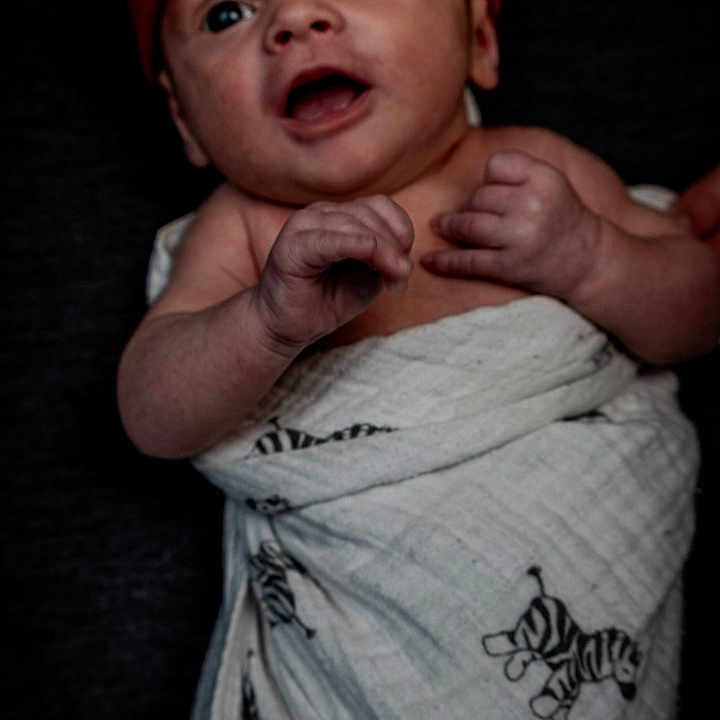 Blue is registered to the contest to win money with this photo: baby, baseballcap, beanie, bodypart, bonnet, cap, clothing, face, finger, hand, happy, hat, head, newborn, person, photography, portrait, skin, smile, tattoo