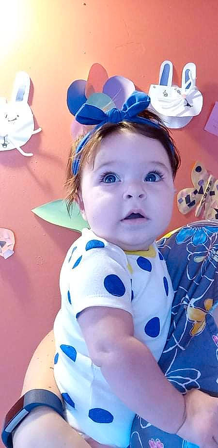 Aurora Raine is registered to the contest to win money with this photo: azure, baby_toddler_clothing, blue, costume_hat, ear, eye, eyebrow, eyelash, face, facial_expression, happy, hat, headgear, iris, person, pink, purple, skin, sleeve, toddler