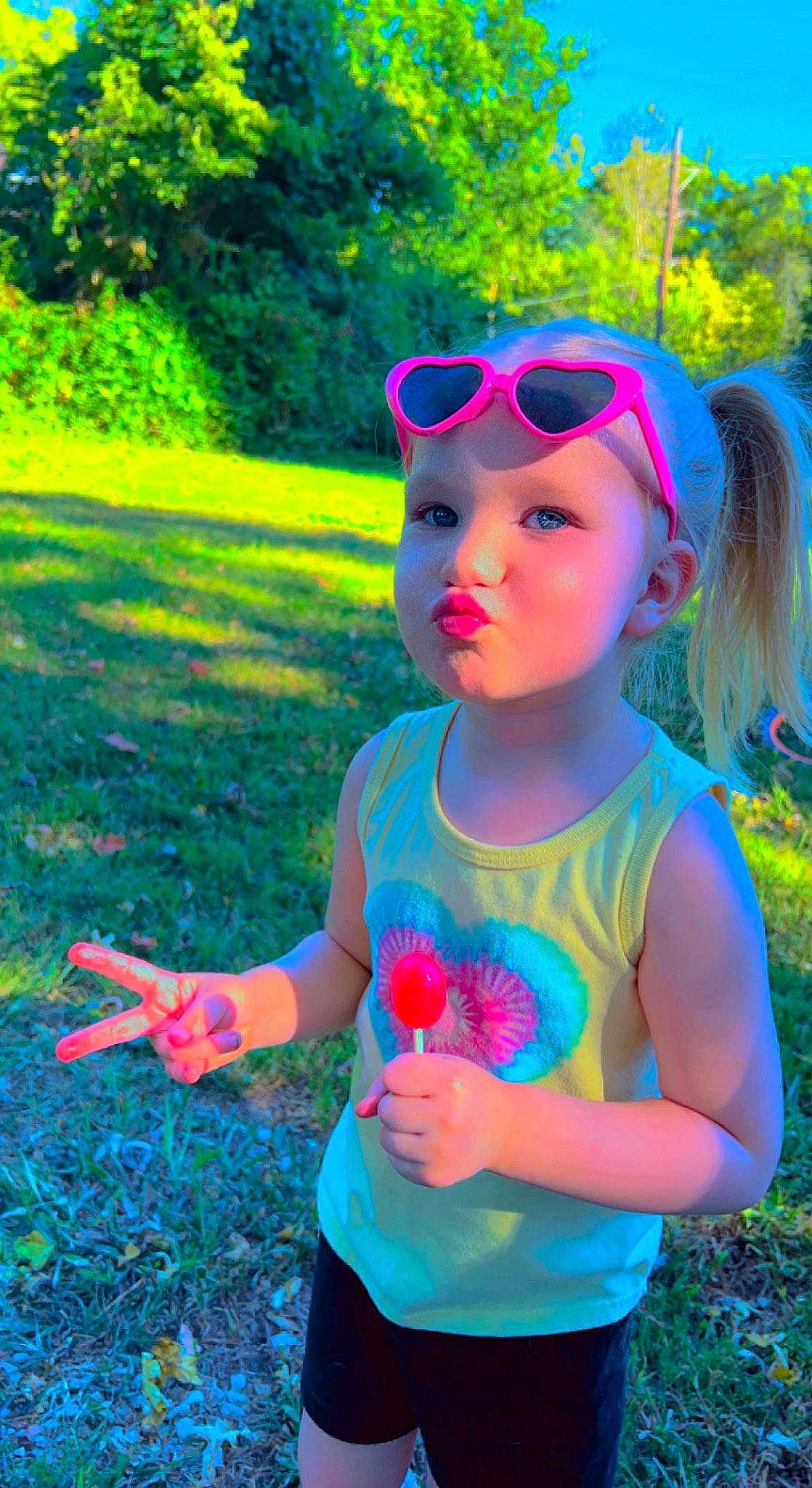 Kailee is registered to the contest to win money with this photo: baby_toddler_clothing, botany, cool, eyewear, facial_expression, goggles, grass, green, happy, headwear, leaf, leisure, light, people_in_nature, person, photograph, pink, plant, sunglasses, sunlight