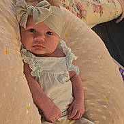 Raina-Lynn joined the competition — help win amazing prizes! baby, infant, headband, bow, pillow, clothing, lace, patterned_pants, face, hands, cozy, soft, indoors, child, newborn, portrait, person, cute, resting, comfortable