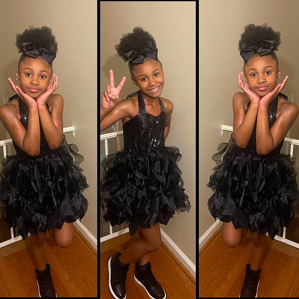 Rylee is registered to the contest to win money with this photo: arm, day_dress, dress, facial_expression, fashion, formal_wear, gesture, hair, happy, head, headgear, joy, leg, neck, one_piece_garment, pattern, person, shoulder, sleeve, smile