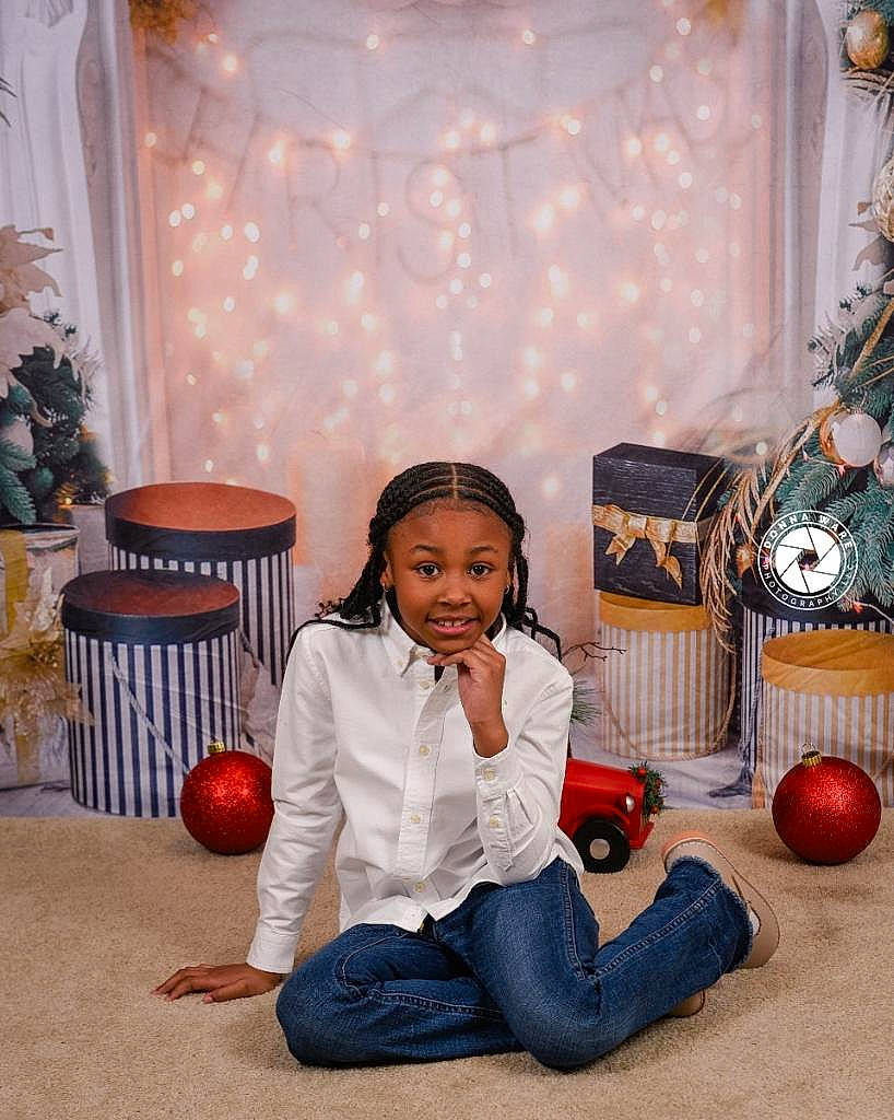 Rylee is registered to the contest to win money with this photo: ball, child, christmas, curtain, denim, drum, event, flooring, fun, happy, headwear, holiday, joy, leisure, musical_instrument, ornament, party, person, room, sitting