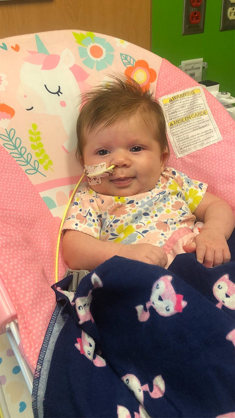 Lucille is registered to the contest to win money with this photo: baby, baby_toddler_clothing, cheek, child, dress, fun, happy, linens, magenta, pattern, people, person, pink, product, room, sitting, skin, sleeve, smile, textile