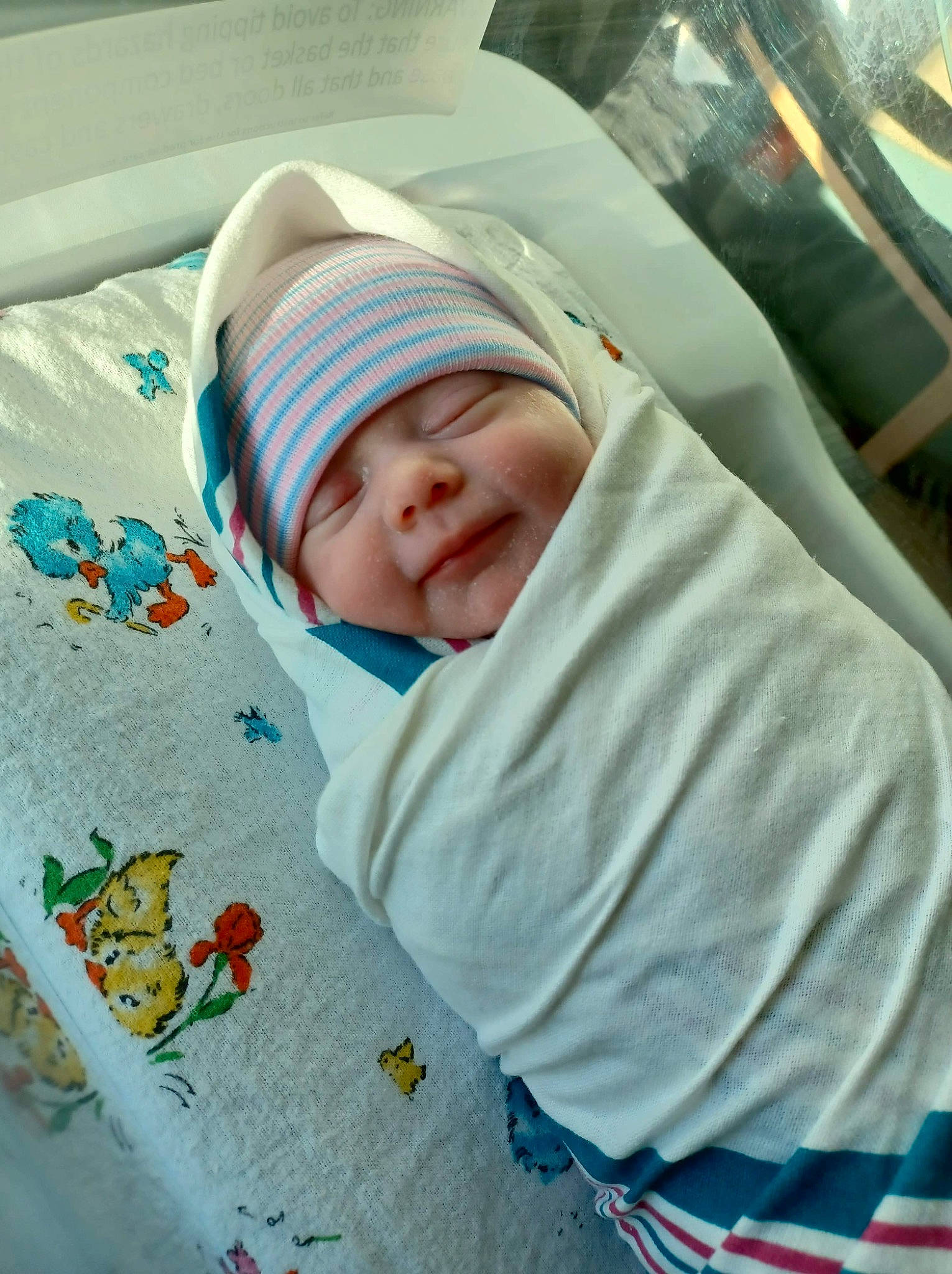 Octavia is registered to the contest to win money with this photo: baby, baby_products, baby_safety, baby_toddler_clothing, beauty, child, comfort, facial_expression, hat, headwear, linens, pattern, person, product, room, sleeve, smile, textile, toddler