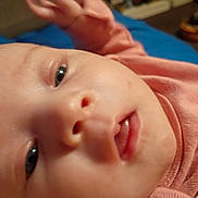 Charlotte joined the competition — help win amazing prizes! baby, close_up, face, infant, pink_clothing, skin, eyes, mouth, nose, indoor, person, child, newborn, portrait, cute, young, expression, soft_light, blurred_background, head