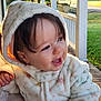 toddler, child, baby, hooded_jacket, smiling, outdoor, porch, sunlight, grass, person, happy, cute, warm_clothing, daylight, face, young_child, nature, home, expression, casual