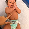 Raian joined the competition — help win amazing prizes! baby, infant, smile, curly_hair, diaper, hand, nail_art, skin, tummy, medical_table, person, cute, happy, lying_down, playful, fingers, child, healthcare, indoors, expression