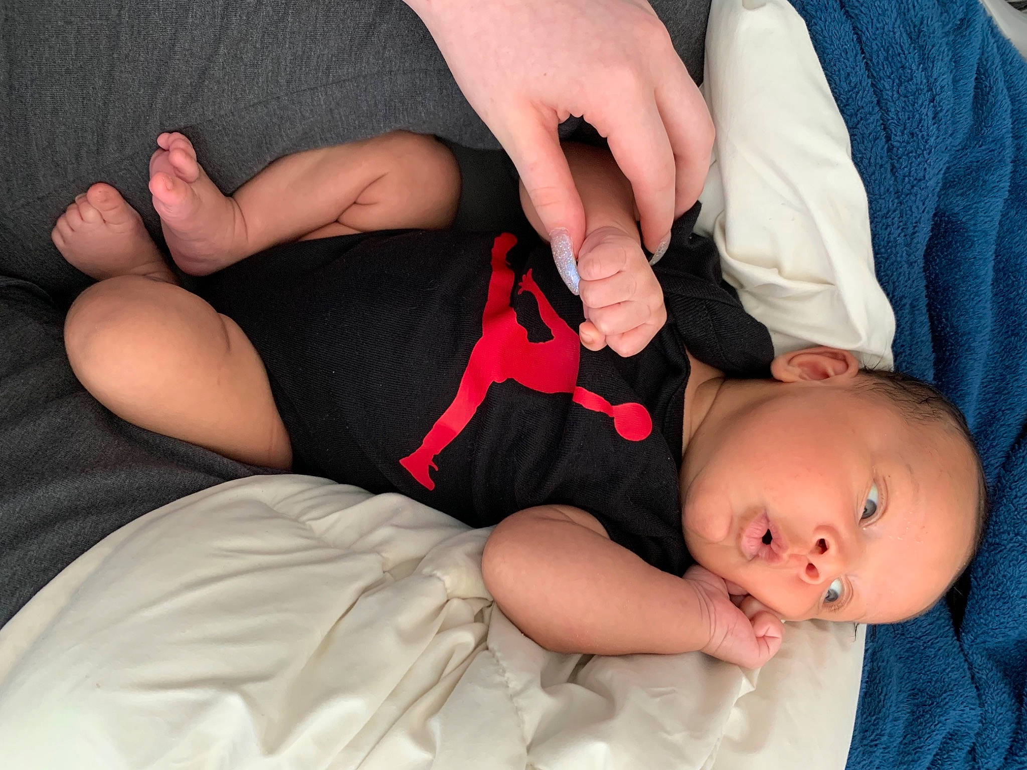 Malikai is registered to the contest to win money with this photo: arm, baby_toddler_clothing, comfort, dress, eye, finger, gesture, hair, hand, human_body, joint, leg, lip, mammal, mouth, muscle, nail, neck, person, skin