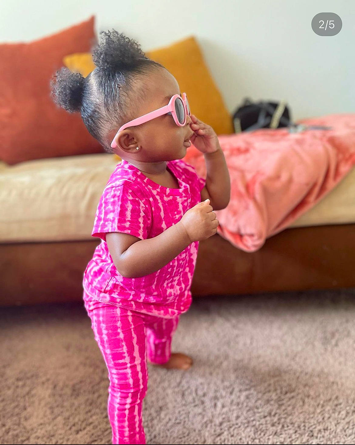 Sanaa joined the competition — help win amazing prizes! arm, baby_toddler_clothing, comfort, couch, dress, floor, flooring, glasses, happy, human_body, joint, leisure, magenta, person, pink, shoulder, sleeve, textile, thigh, toddler