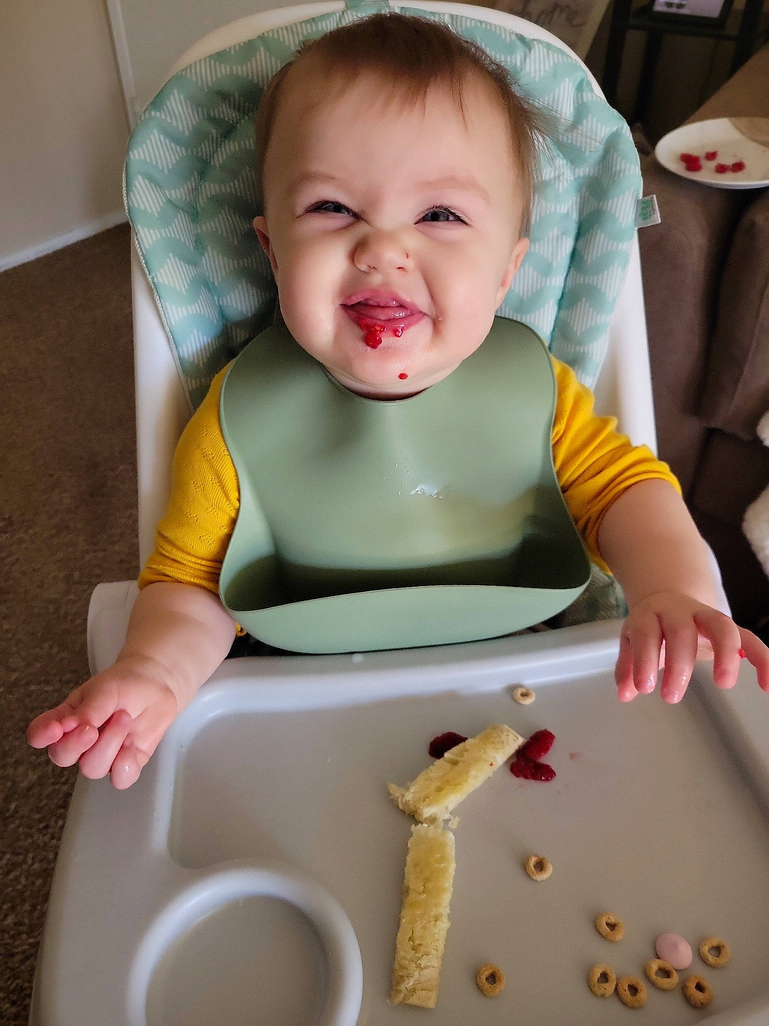 Ryan is registered to the contest to win money with this photo: baby, baby_products, baby_safety, baby_toddler_clothing, bib, chair, cheek, child, comfort, comfort_food, fun, happy, person, play, sitting, sleeve, smile, tableware, toddler, yellow