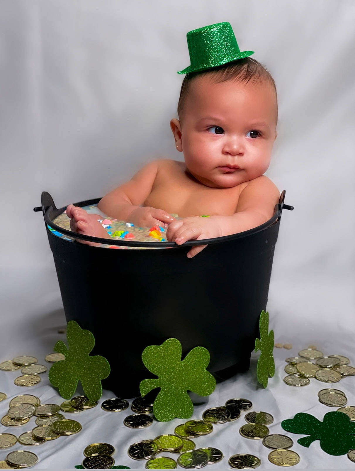 Marcellus is registered to the contest to win money with this photo: baby, baby_products, baby_safety, baby_toddler_clothing, baby_toys, bathing, cap, child, costume_hat, fashion_accessory, grass, green, happy, jewellery, pattern, person, product, room, sitting, toddler
