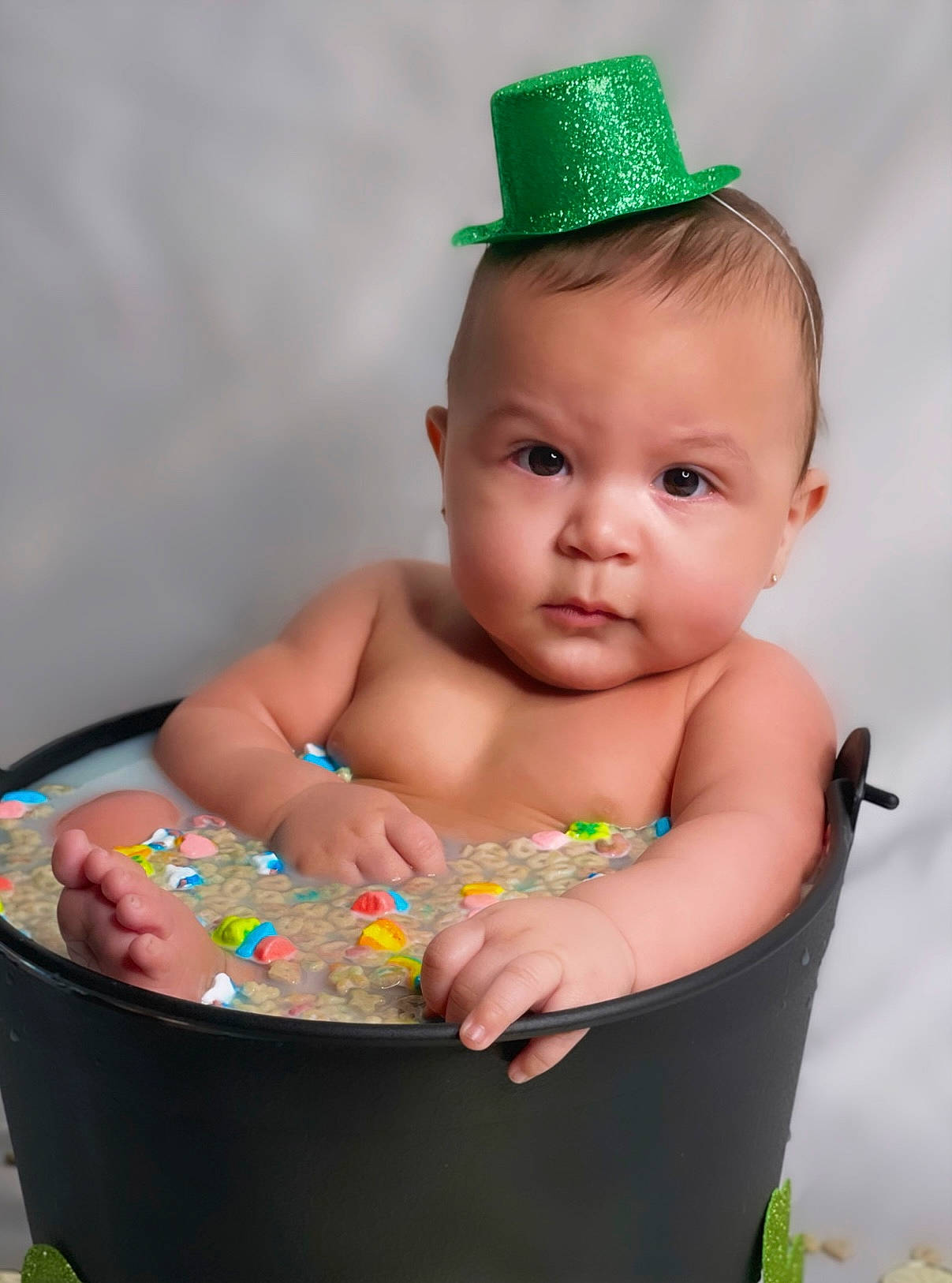 Marcellus is registered to the contest to win money with this photo: baby, baby_products, baby_toddler_clothing, bathing, cheek, child, costume_hat, event, fashion_accessory, fun, grass, happy, holiday, jewellery, party_supply, person, product, sitting, skin, sweetness