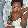 Phor'Ever joined the competition — help win amazing prizes! baby, infant, child, portrait, sitting, lying_down, diaper, pacifier, striped_cushion, blanket, bed, indoor, close_up, face, eyes, curly_hair, dark_skin, bare_arms, relaxed, photography