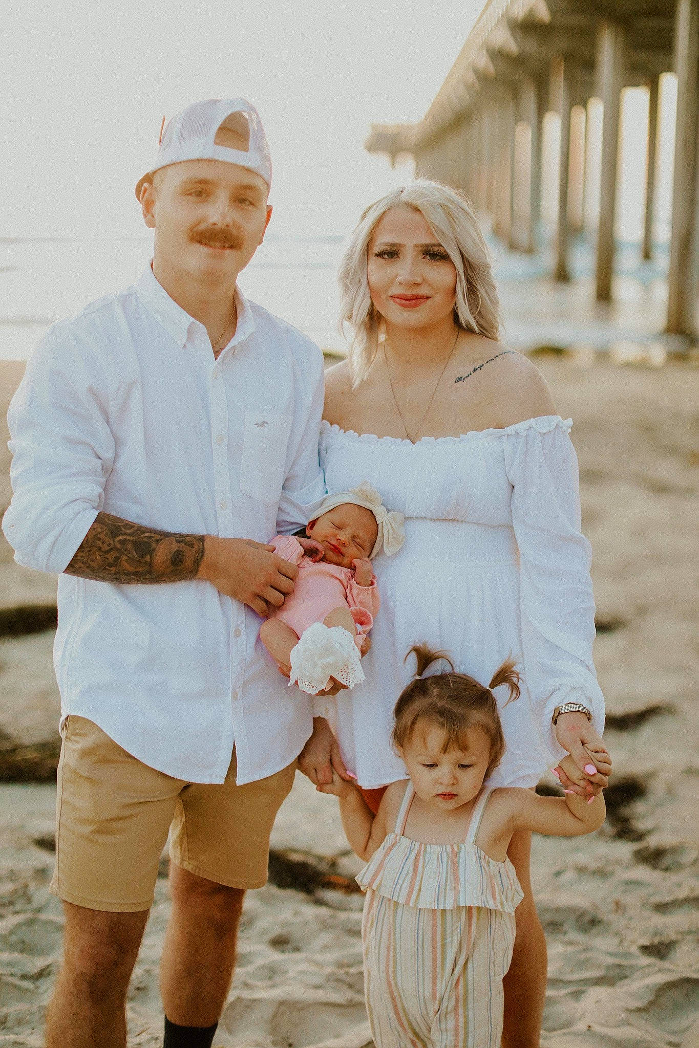 Kynlee is registered to the contest to win money with this photo: bride, clothing, facial_expression, fashion, flash_photography, fun, gesture, happy, hat, headwear, human, interaction, joy, people_in_nature, people_on_beach, person, photograph, shorts, sleeve, standing