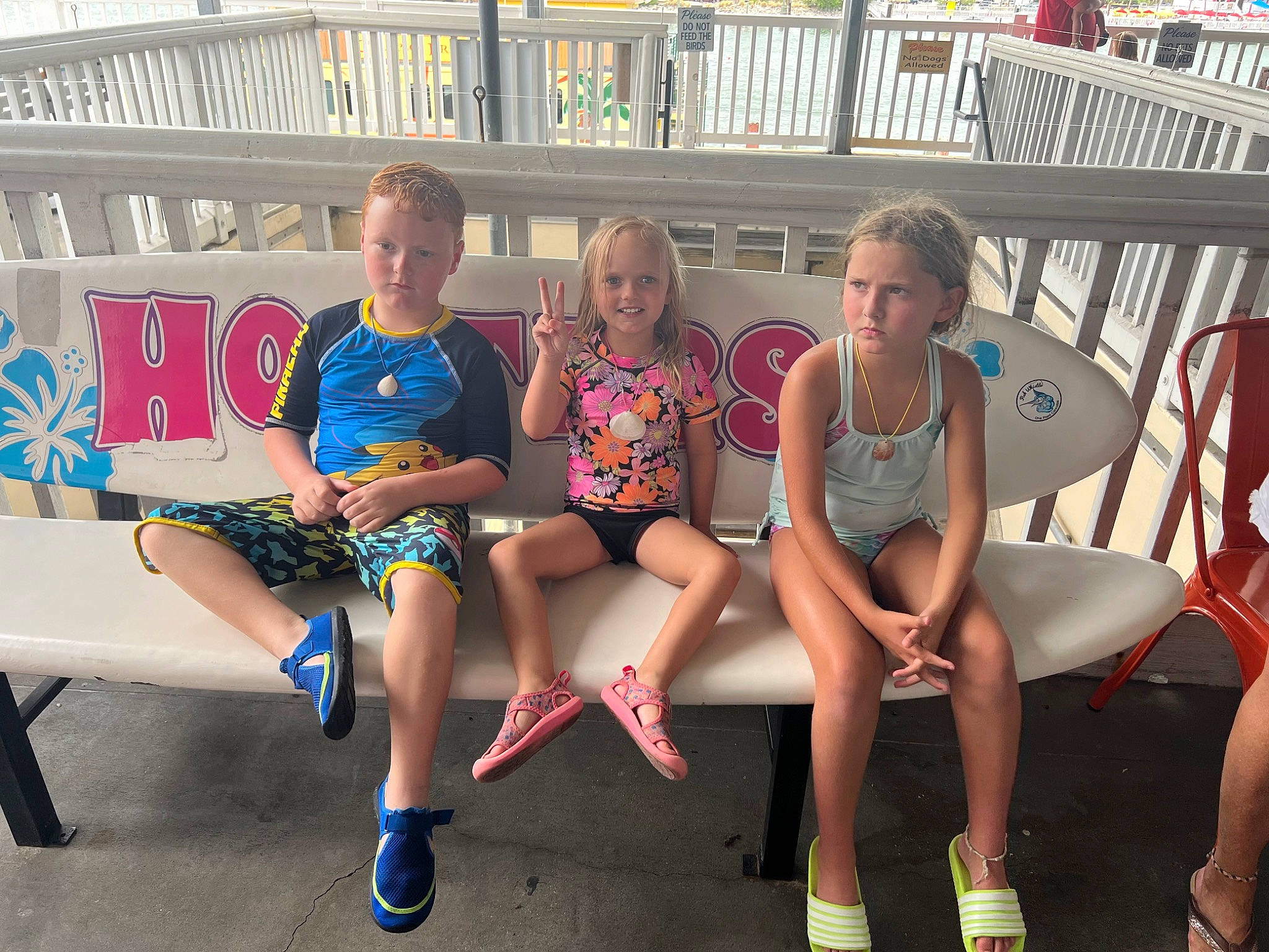 Journie is registered to the contest to win money with this photo: chair, electric_blue, event, eyewear, fence, fun, human_leg, joy, knee, lap, leisure, outdoor_furniture, person, recreation, shorts, sitting, smile, summer, t_shirt, team