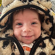 Skylar is registered to the contest to win money with this photo: baby, child, hoodie, fluffy, animal_print, smiling, cozy, cute, face, closeup, infant, warm_clothing, zipper, happy, portrait, young_child, indoor, clothing, baby_clothes, headwear