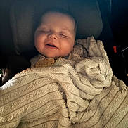 Josiah-Jay joined the competition — help win amazing prizes! baby, sleeping, blanket, car_seat, cozy, infant, smile, child, soft, comfort, cute, face, resting, peaceful, warm, fabric, portrait, indoors, closeup, head