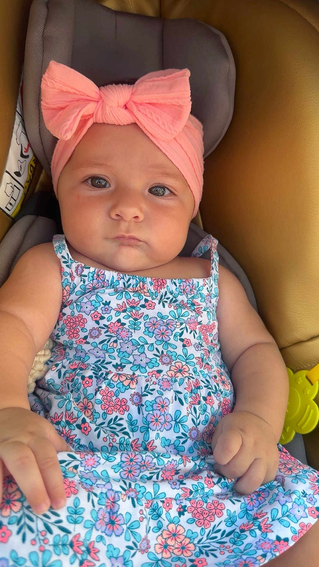 Joyce participe au concours pour gagner de l'argent avec cette photo : baby, child, infant, headband, pink, bow, floral_dress, car_seat, seat, cute, serious, portrait, person, skin, hand, clothing, indoor, closeup, expression, young