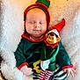baby, blanket, child, christmas_elf, costume, cozy, cute, elf_doll, festive, green_clothing, holiday, holiday_season, infant, red_hat, resting, sleeping, smiling_toy, soft_texture, striped_pants, toy