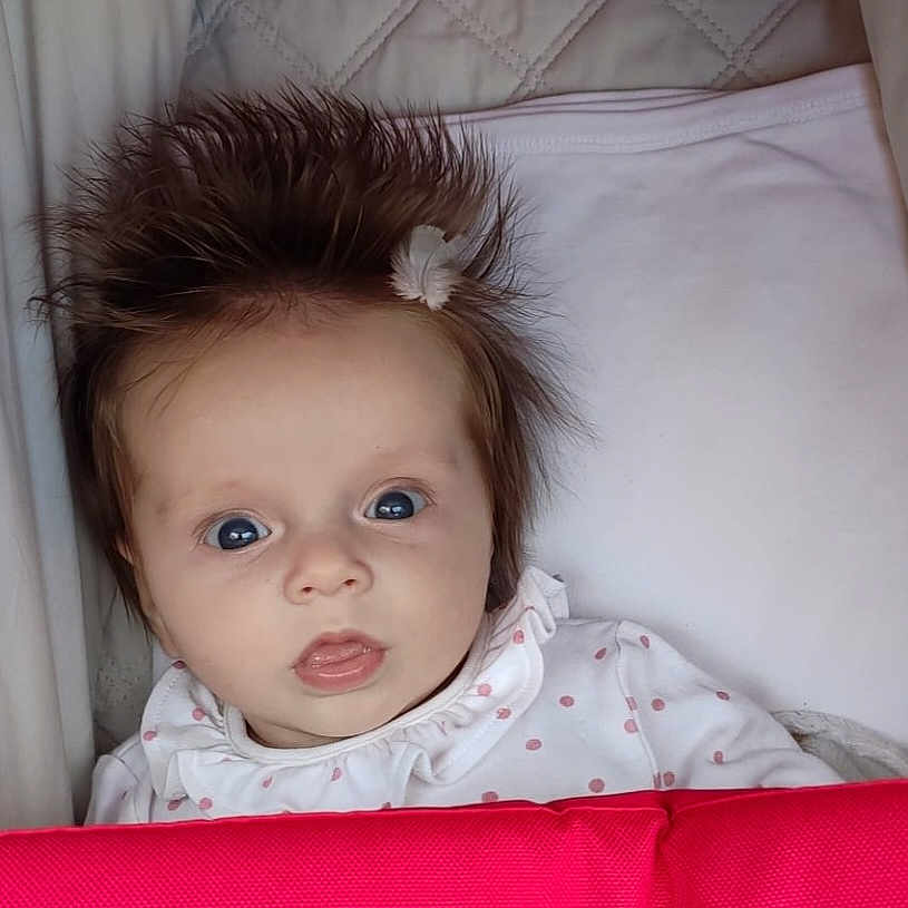 Emma is registered to the contest to win money with this photo: baby, bed, bedroom, blanket, couch, crib, cushion, face, furniture, hair, happy, head, homedecor, indoors, infantbed, newborn, person, photography, portrait, room