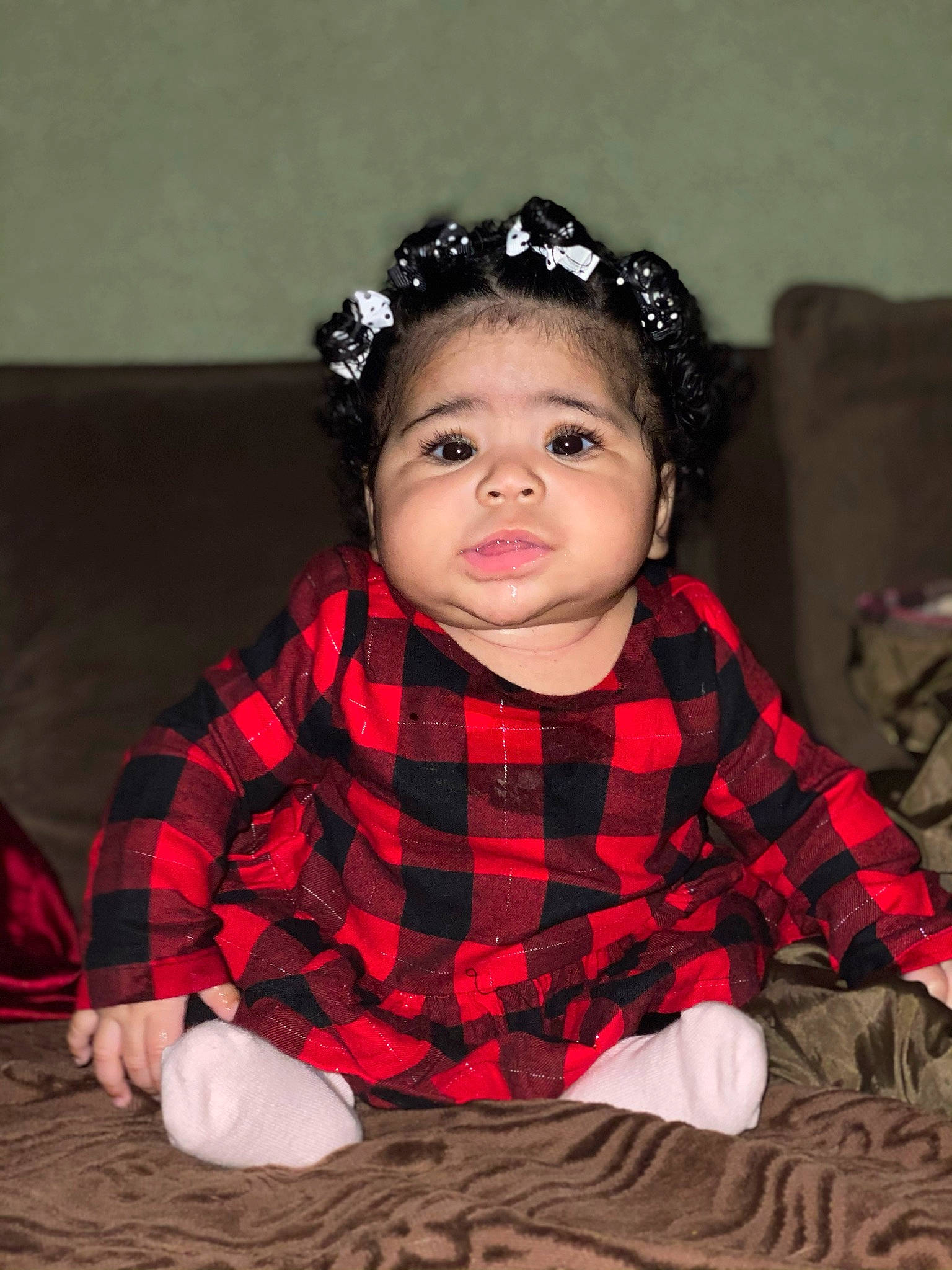 Kylah joined the competition — help win amazing prizes! baby, baby_toddler_clothing, cheek, child, costume_accessory, couch, face, fashion_accessory, goggles, hair_accessory, headband, headgear, headpiece, mouth, nose, pattern, person, plaid, sitting, sock