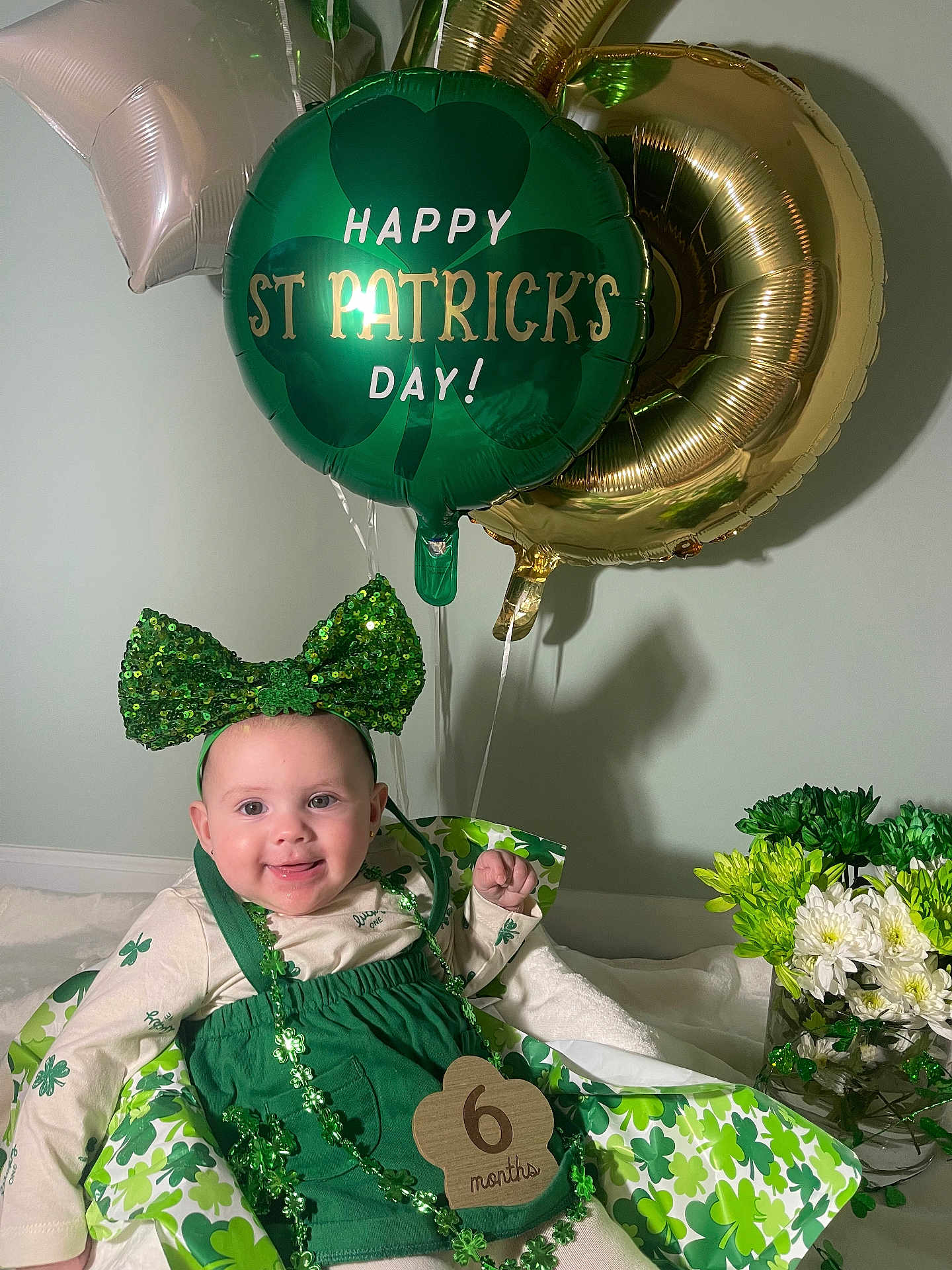 Eliza joined the competition — help win amazing prizes! baby, infant, smile, st_patricks, balloon, green_bow, headband, beads, six_months, milestone, flowers, vase, decorations, shamrock, party, portrait, indoor, holiday, outfit, tablecloth