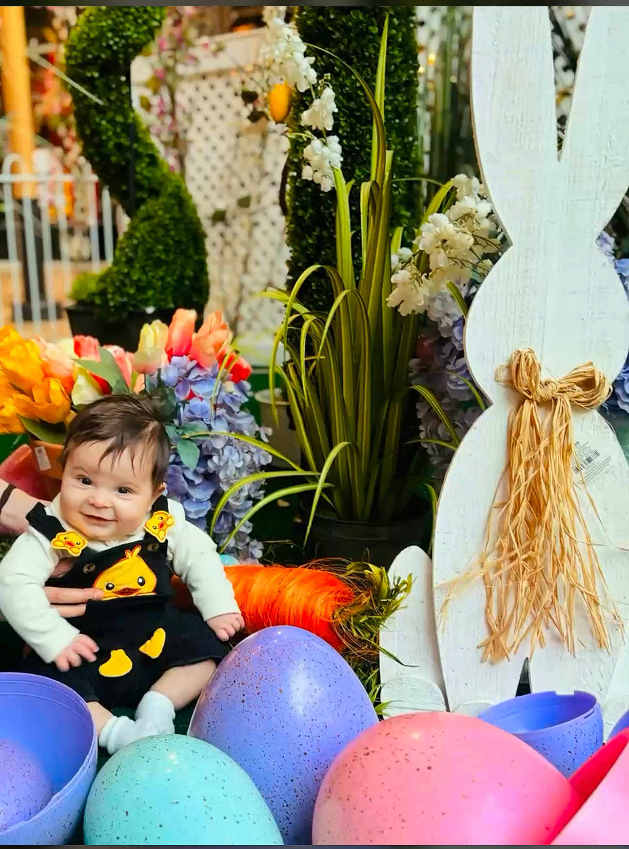 Enzo Oreilly is registered to the contest to win money with this photo: baby, child, easter, easter_eggs, flowers, plants, bunny_decoration, spring, colorful, cute, smiling, festive, holiday, portrait, indoors, decor, happy, sitting, person, seasonal