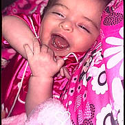 Amara Garcia joined the competition — help win amazing prizes! baby, black_border, blanket, child, close_up, cute, face, floral_pattern, hand, heart_doodle, indoor, infant, lying_down, patterned_clothing, phone_screenshot, pink, portrait, sleepy, smiling, yawning